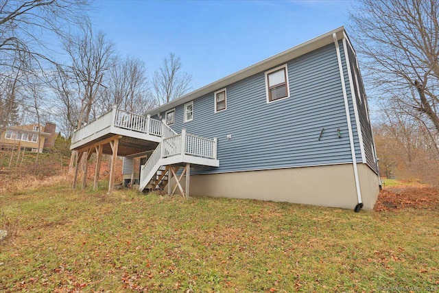 back of property with a yard and a deck