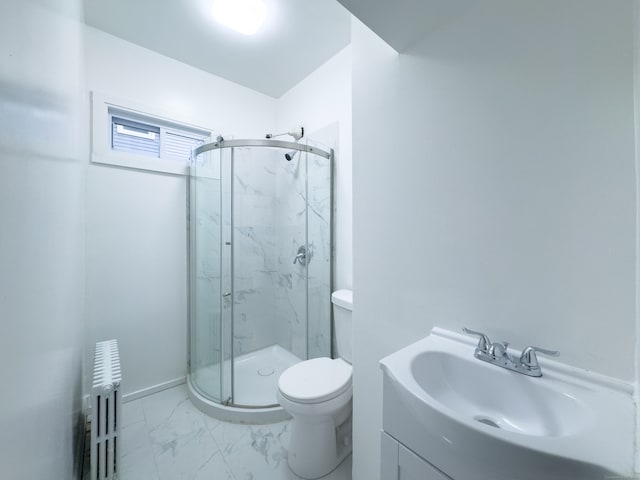 bathroom featuring vanity, toilet, a shower with door, and radiator heating unit