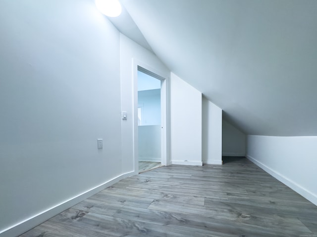 bonus room featuring hardwood / wood-style floors and lofted ceiling