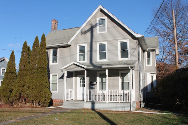 view of front of house with a porch and a front lawn