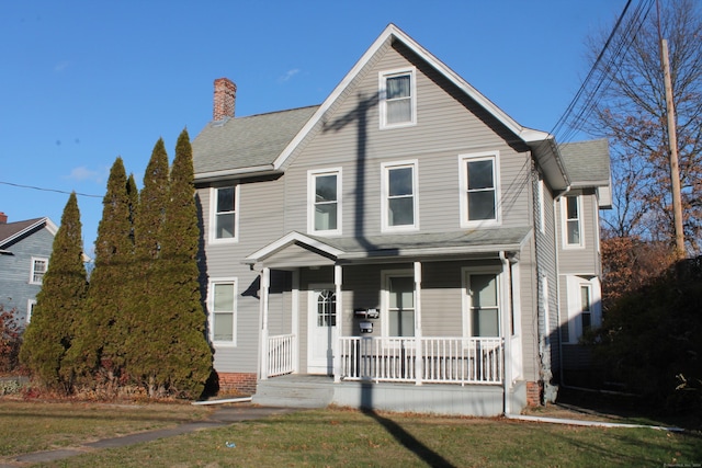 view of front of home featuring covered porch and a front lawn