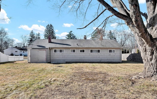 back of house featuring a yard