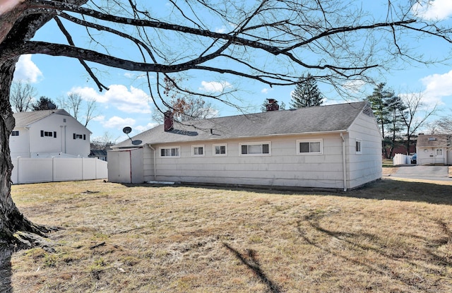 back of property featuring a yard