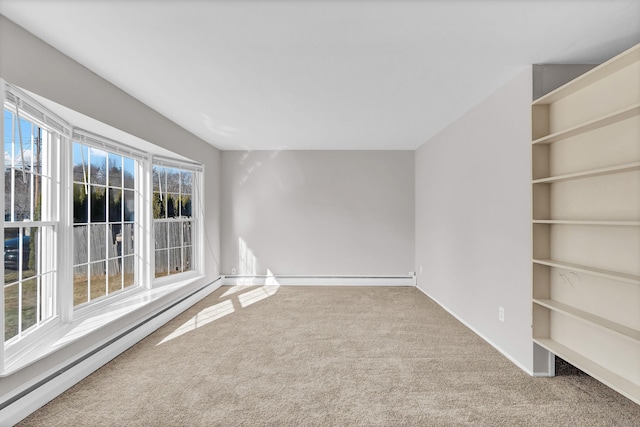 spare room featuring carpet and a baseboard radiator