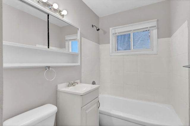 full bathroom with vanity, tiled shower / bath combo, and toilet