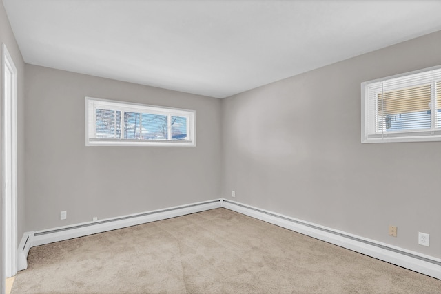 unfurnished room with light carpet and a baseboard heating unit