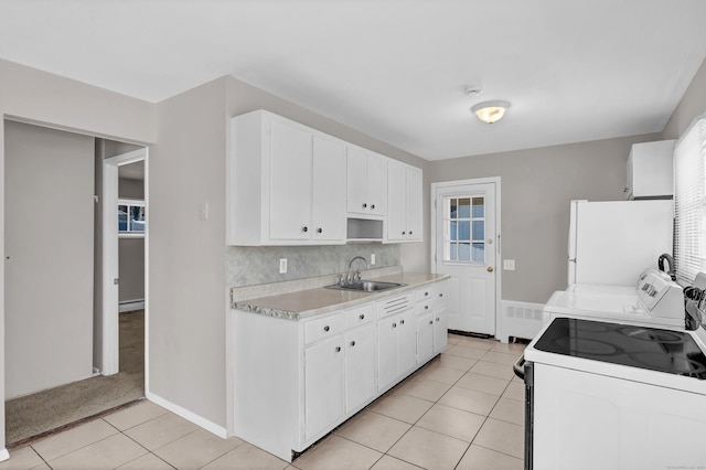 kitchen featuring sink, white cabinets, and white appliances