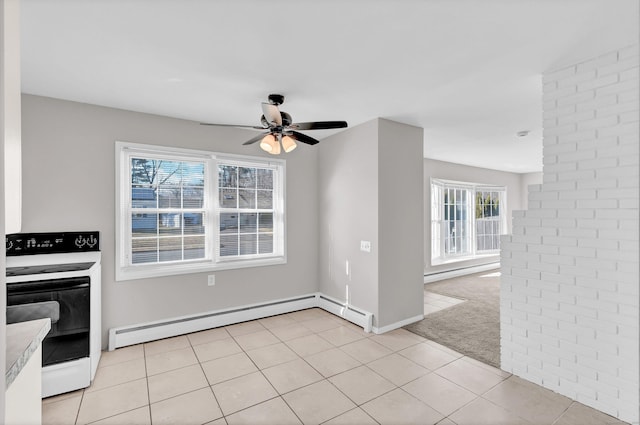 interior space featuring ceiling fan, a healthy amount of sunlight, and a baseboard heating unit