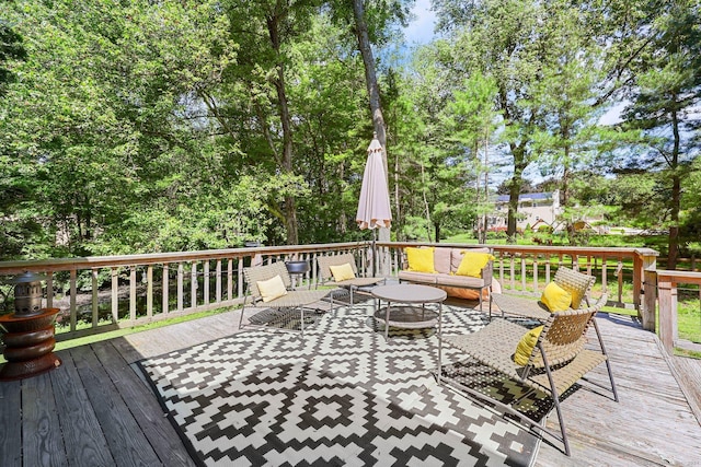 wooden terrace with an outdoor living space