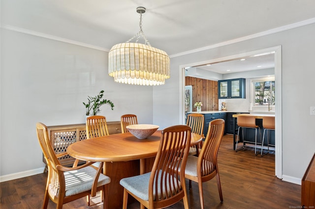 dining space with dark wood-type flooring and crown molding