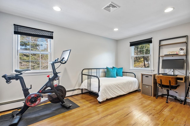 bedroom featuring multiple windows and light hardwood / wood-style floors