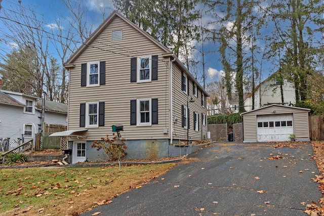 view of front facade with a garage, an outdoor structure, and a front yard