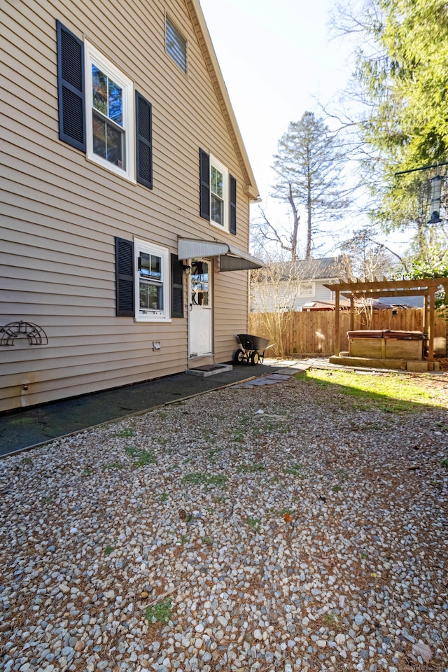 back of house featuring a pergola