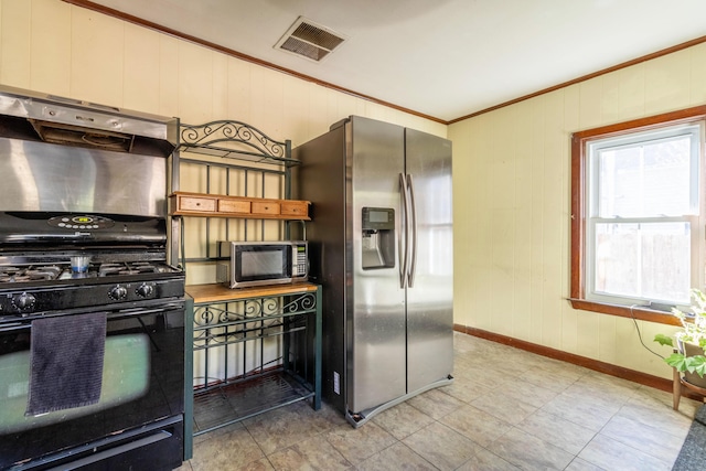 kitchen featuring appliances with stainless steel finishes and crown molding