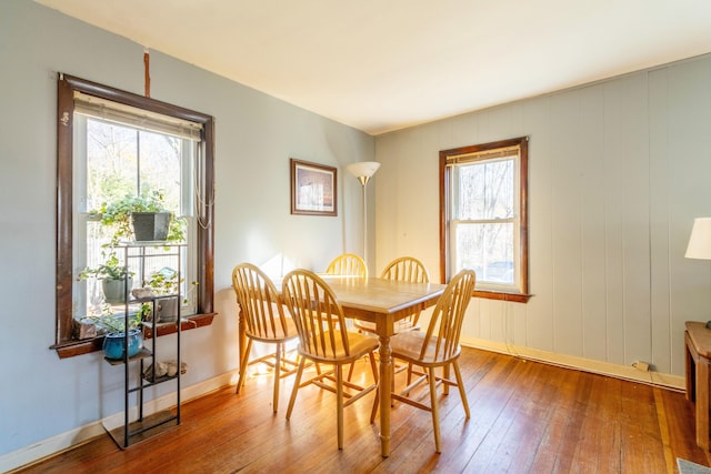 dining space with plenty of natural light and wood-type flooring