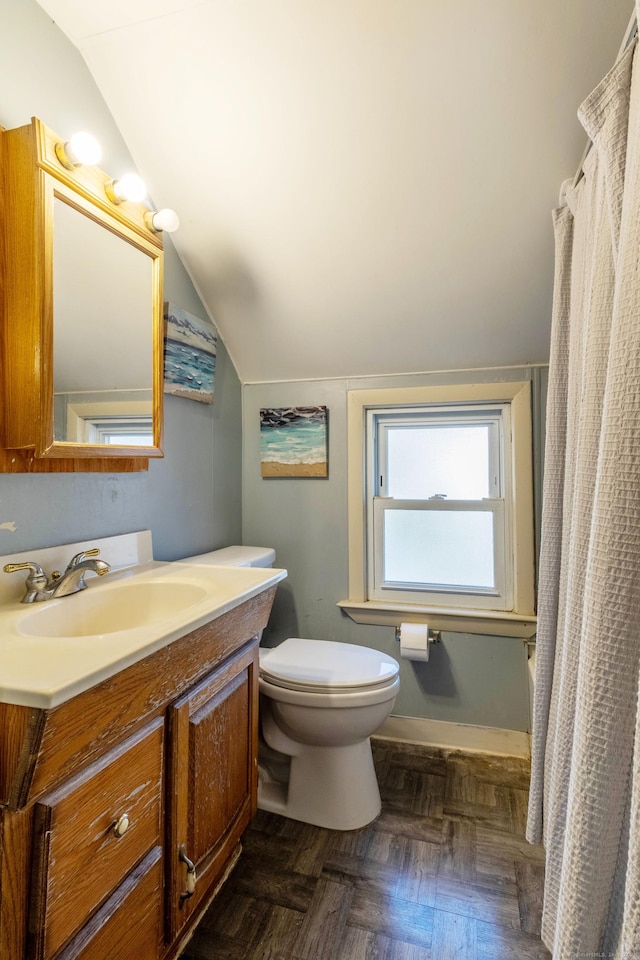 bathroom featuring parquet floors, a shower with curtain, lofted ceiling, toilet, and vanity