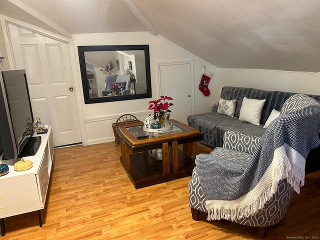 living room featuring light hardwood / wood-style floors and vaulted ceiling