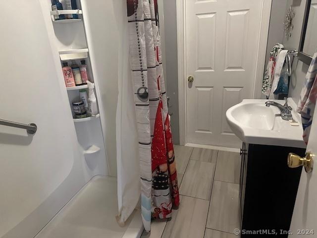 bathroom featuring vanity and shower / bath combination with curtain