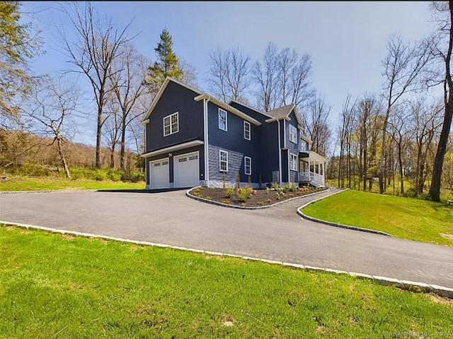 view of property exterior with a yard and a garage