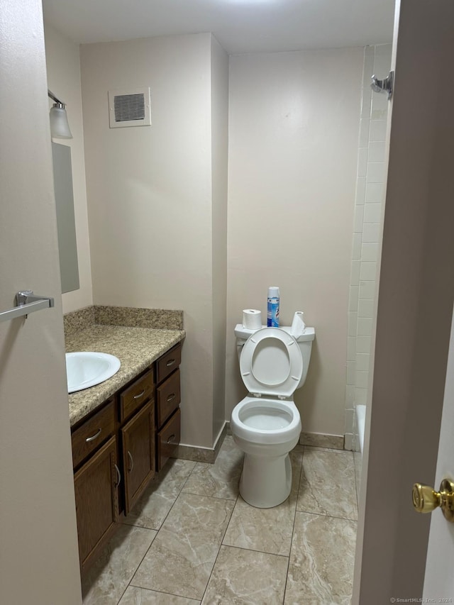 full bathroom featuring washtub / shower combination, vanity, and toilet