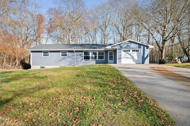 ranch-style house featuring a garage and a front lawn