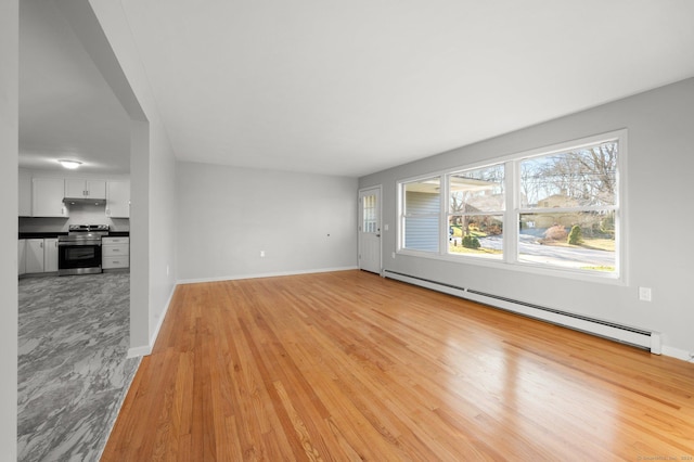 unfurnished living room with light hardwood / wood-style floors and a baseboard radiator