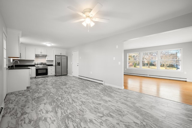 kitchen with white cabinetry, ceiling fan, a baseboard heating unit, and appliances with stainless steel finishes