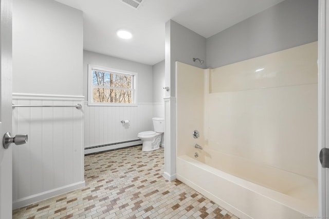 bathroom with baseboard heating, tile patterned floors,  shower combination, and toilet