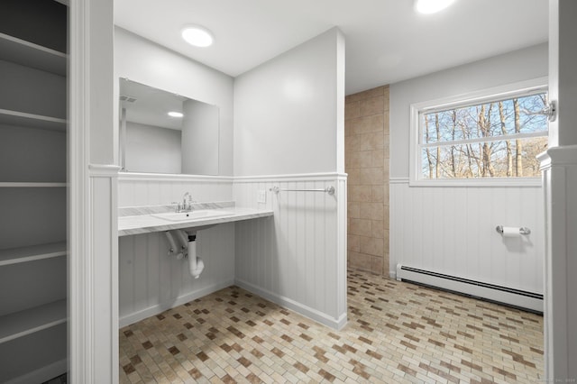 bathroom featuring sink and a baseboard radiator