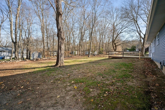 view of yard featuring a wooden deck