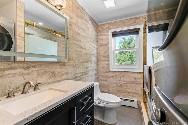 bathroom with tile patterned floors, vanity, baseboard heating, tile walls, and toilet