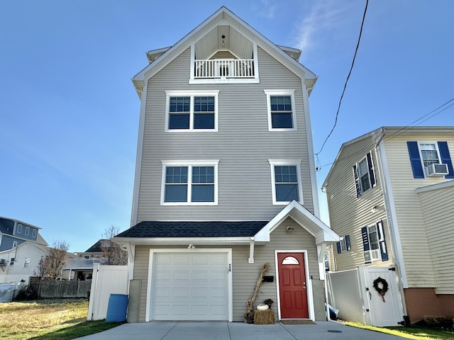 view of property with cooling unit, a garage, and a balcony