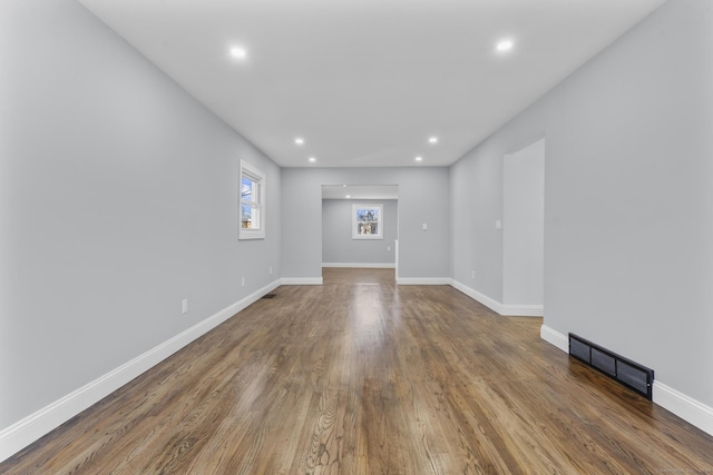 unfurnished living room featuring dark hardwood / wood-style floors