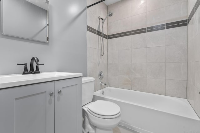 full bathroom with vanity, toilet, and tiled shower / bath