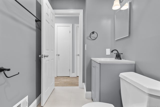 bathroom featuring tile patterned flooring, vanity, and toilet