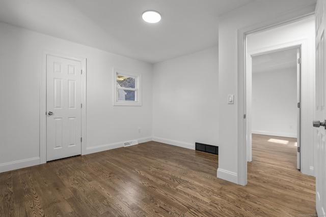 unfurnished room with dark hardwood / wood-style floors