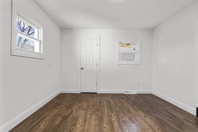 spare room with dark hardwood / wood-style floors