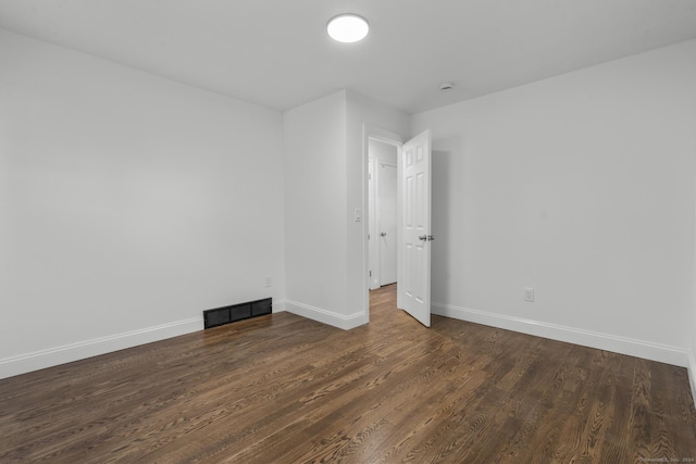 empty room with dark hardwood / wood-style floors