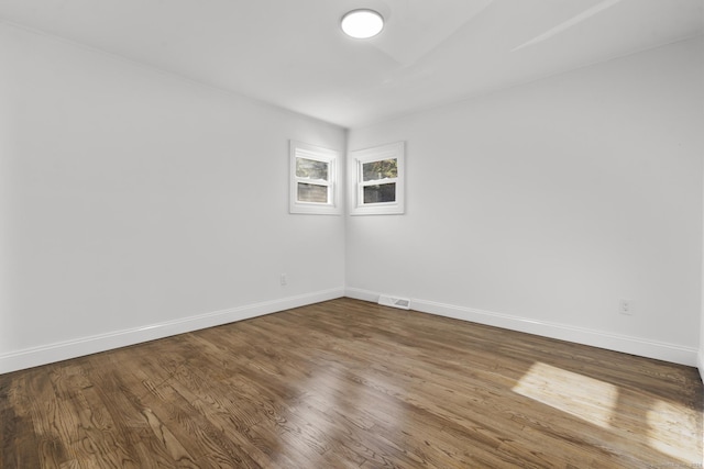 unfurnished room with wood-type flooring