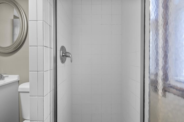 room details featuring toilet and a shower with door