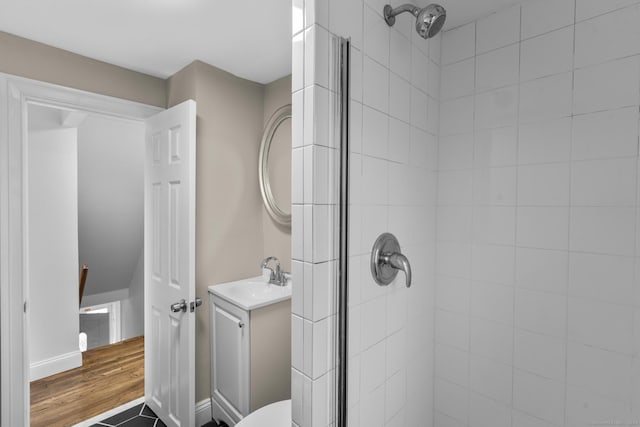 bathroom with hardwood / wood-style floors, vanity, and an enclosed shower