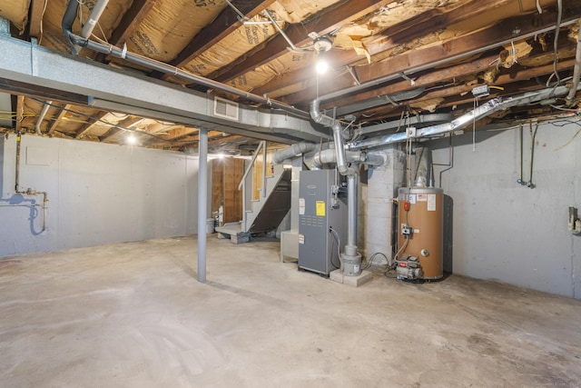 basement featuring heating unit and water heater