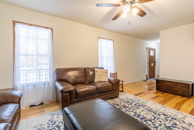 living room with light hardwood / wood-style floors, plenty of natural light, and ceiling fan