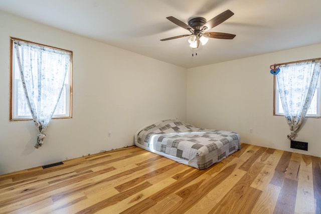 bedroom with ceiling fan and light hardwood / wood-style flooring