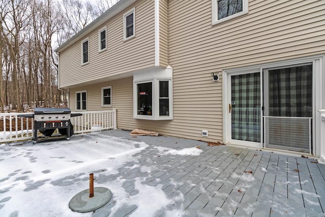 snow covered deck with area for grilling