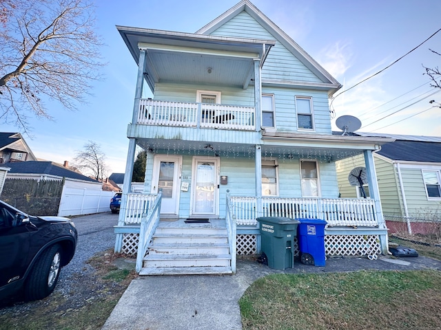 view of front of home featuring covered porch and a balcony