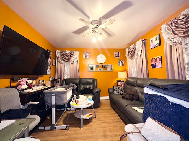 living room featuring light wood-type flooring and ceiling fan