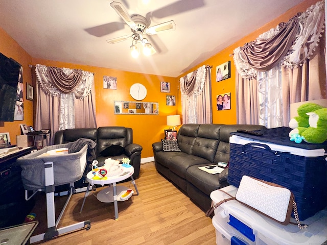 living room featuring ceiling fan and light hardwood / wood-style flooring