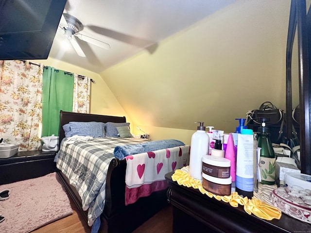 bedroom with ceiling fan, wood-type flooring, and lofted ceiling