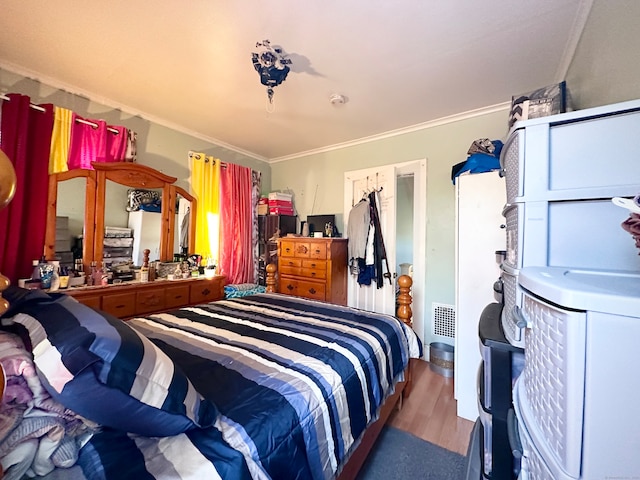 bedroom featuring wood-type flooring and ornamental molding